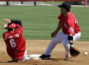 Kia Tigers shortstop Kyu-Sik Han, confident of being safe at second, shows off by singing 