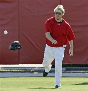 Dunn shows off his improved defensive skills during fly ball practice.