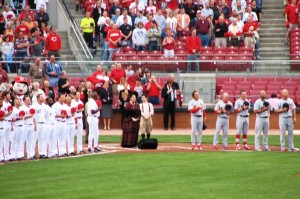 Cardinals and Reds players line up for the anthem