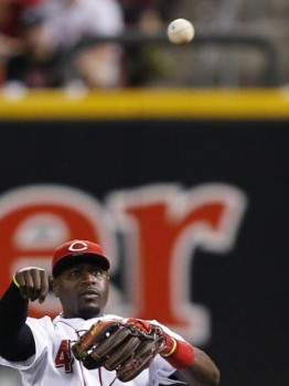 Brandon Phillips throws from his seat at second base. (Photo by Joe Robbins/Getty Images)