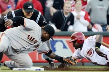 Brandon Phillips is out trying to snag third on a passed ball. (AP Photo/Michael Keating)
