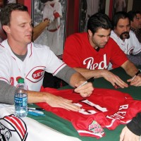 Jay Bruce signs the jersey of a Reds Heads kids club member.