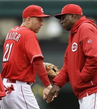 Cincinnati Reds manager Dusty Baker, right, congratulates third baseman Todd Frazier (21) after they defeated the Chicago Cubs 1-0 in a baseball game on Wednesday, April 24, 2013, in Cincinnati. Frazier accounted for the game's only run with a home run. (AP Photo/Al Behrman)