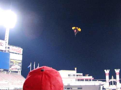 Army dude parachuting onto the field after the game