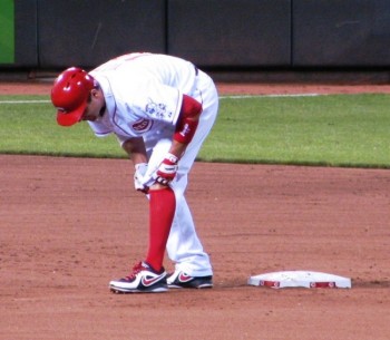 Votto puts on a knee brace after an automatic double