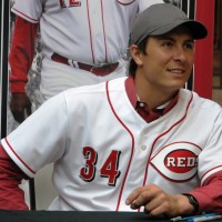 Homer Bailey smiles as he leans in for a forbidden photo with a fan.