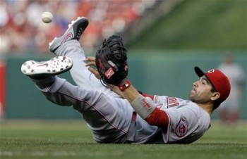 Joey Votto throws from his back to make the final out in a game against the Cardinals