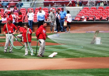 The grounds crew prepares the infield dirt