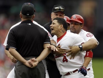 It's nice that Yadi has his brother at first base coach to make a big show of holding him back. (AP Photo/Jeff Roberson)