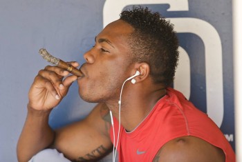 Reds closer Aroldis Chapman smokes a cigar.