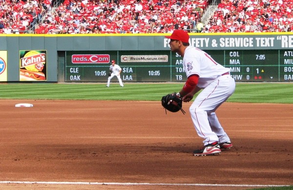Votto crouches at first as the pitch is delivered.
