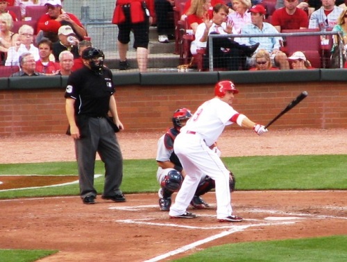 Votto stretching out his bat while waiting on the pitch