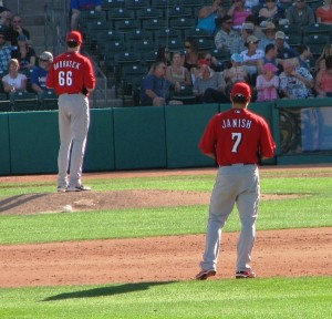 Ondrusek pitches while Janish watches from shortstop